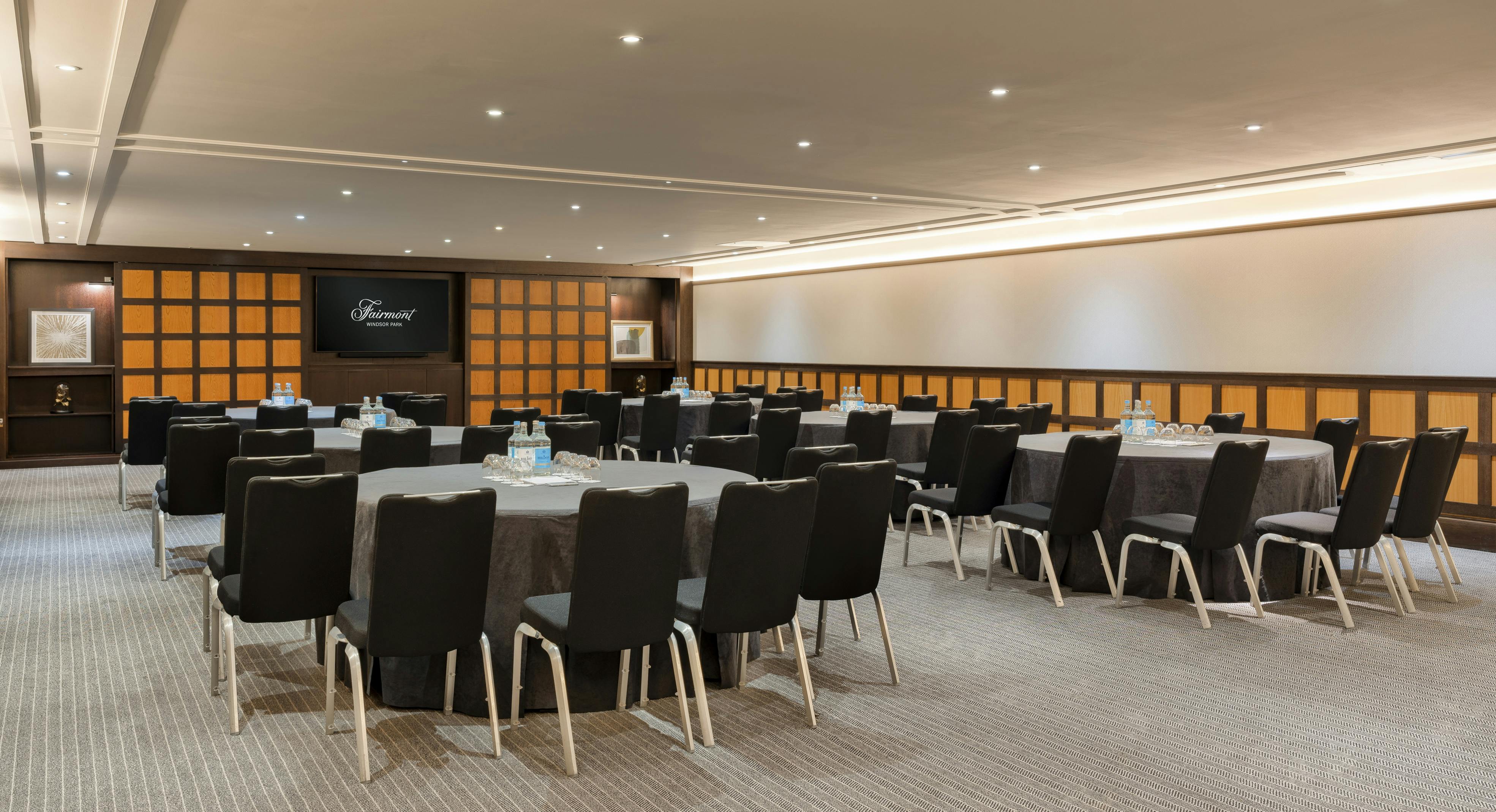 Corporate meeting space at Fairmont Windsor Park with round tables for workshops.