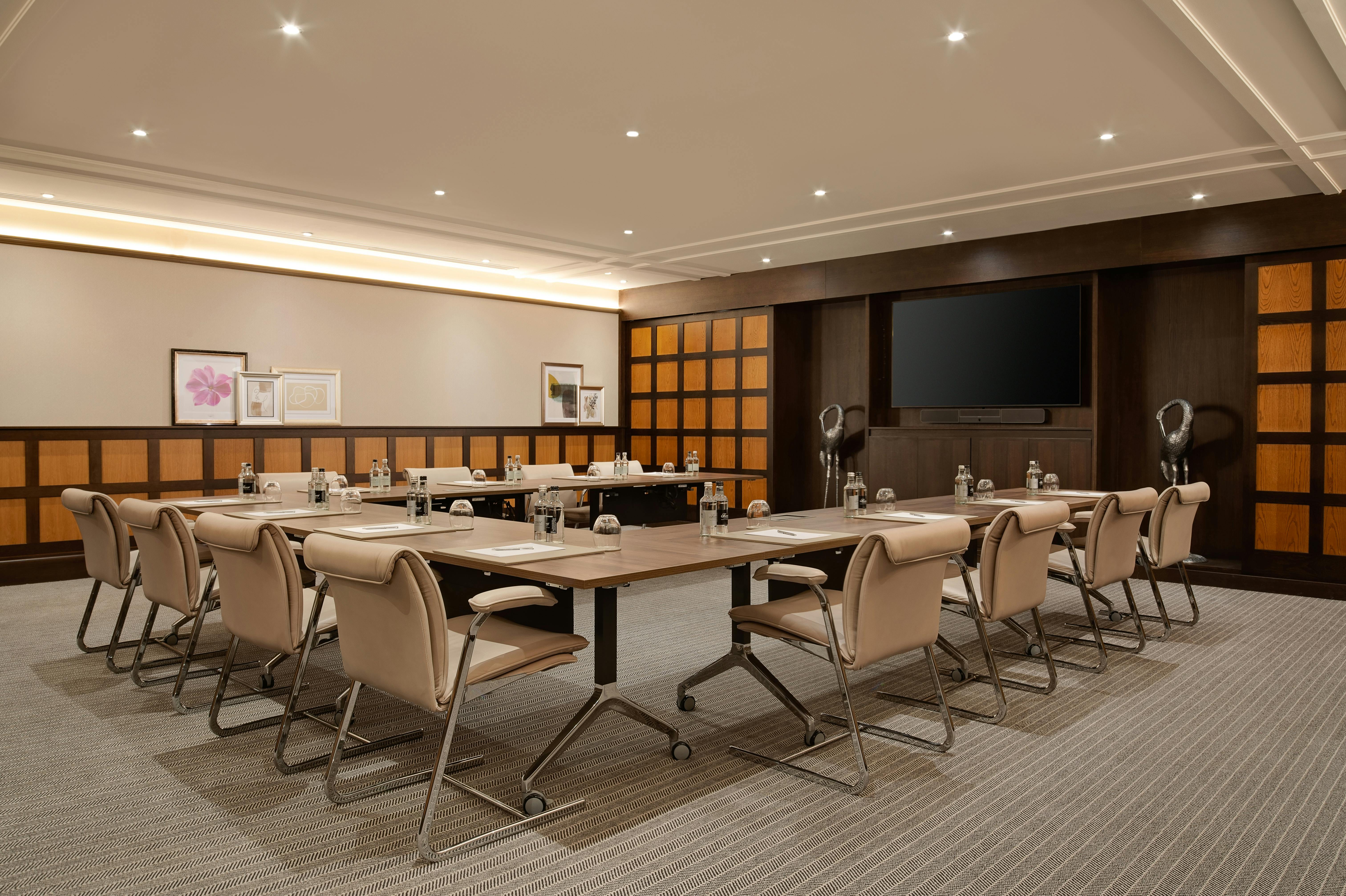 Meeting room at Fairmont Windsor Park with central table, ideal for professional events.