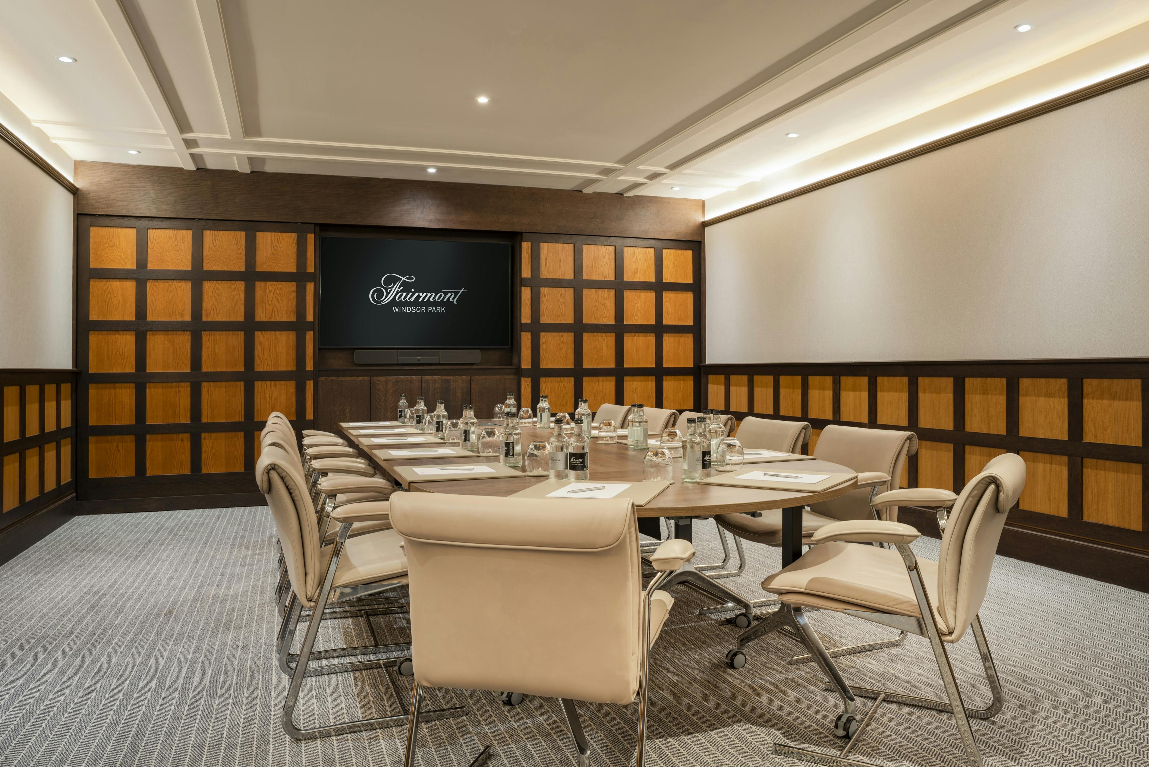 Sophisticated meeting room with oval table at Fairmont Windsor Park for corporate events.