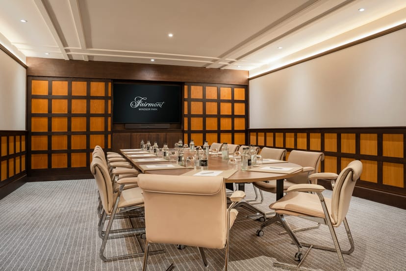 Sophisticated meeting room with oval table at Fairmont Windsor Park for corporate events.