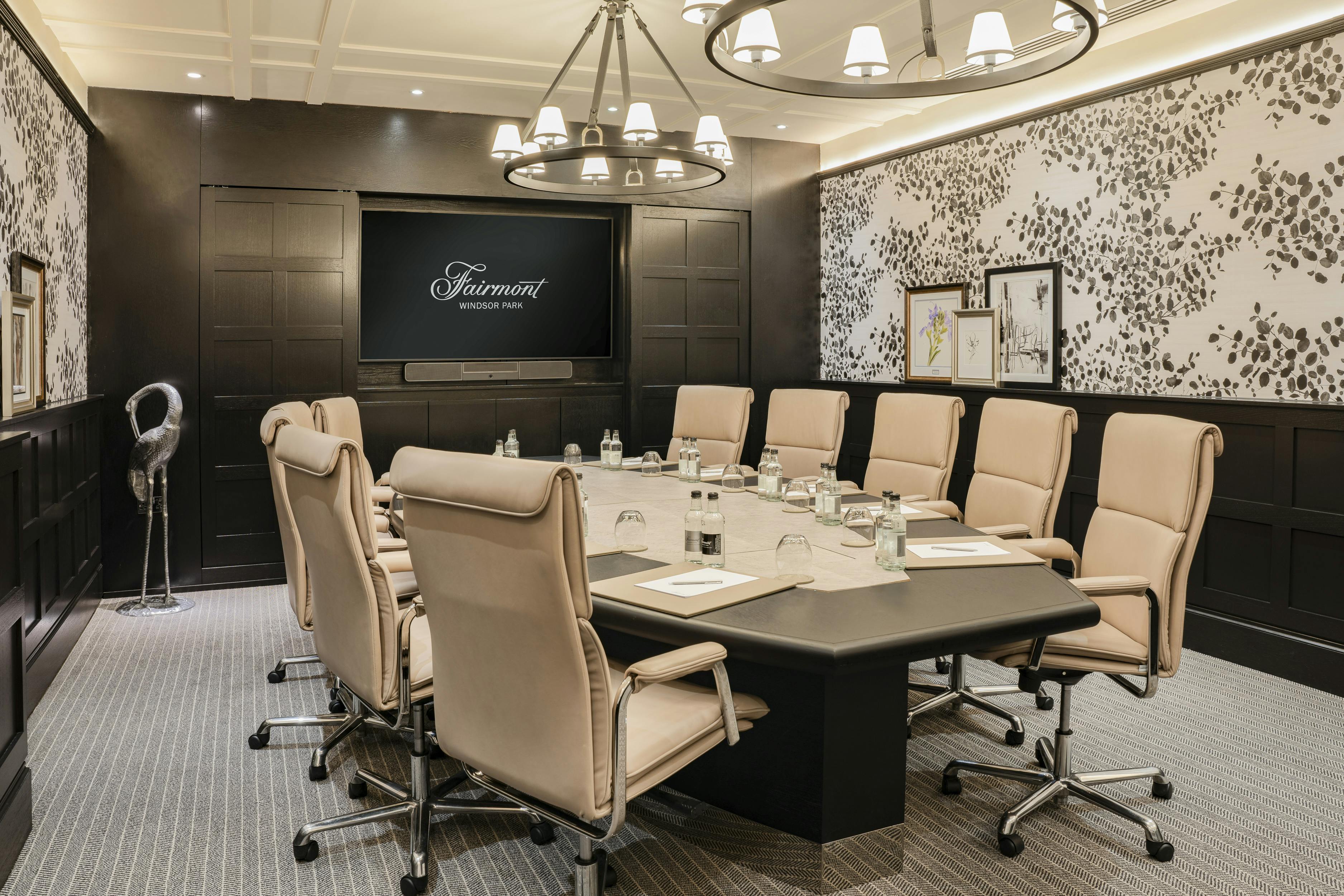 Sophisticated meeting room with plush chairs for corporate events at Fairmont Windsor Park.