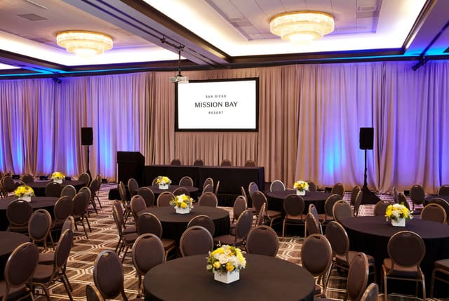 Elegant event space with round tables, ideal for corporate meetings and banquets.