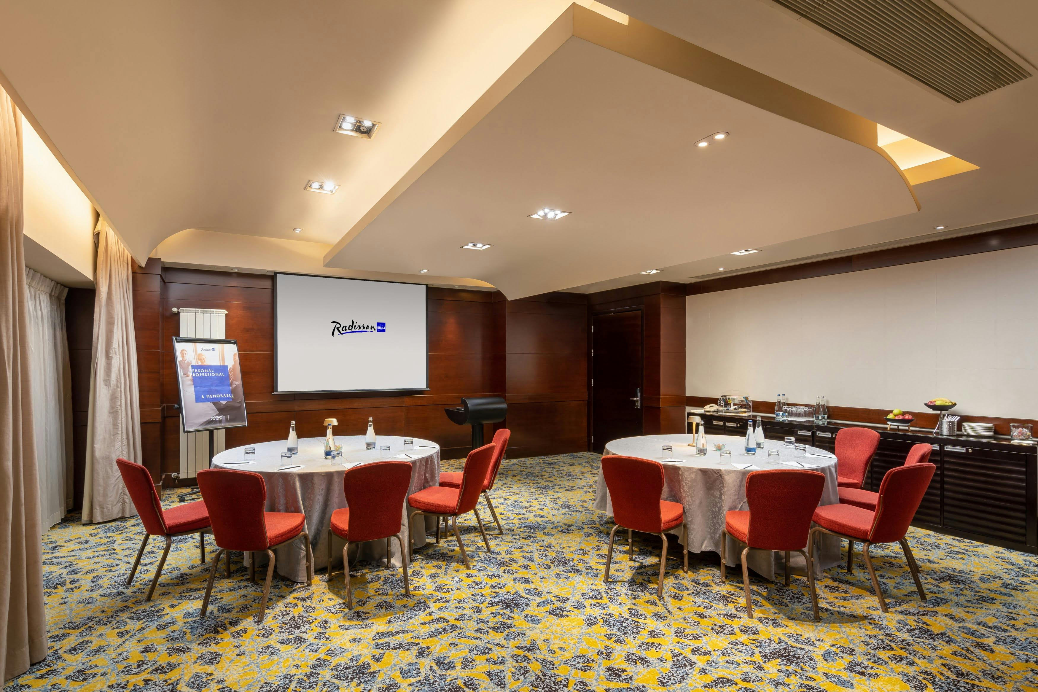 Taygete meeting room at Radisson Blu Bucharest, featuring round tables for corporate events.