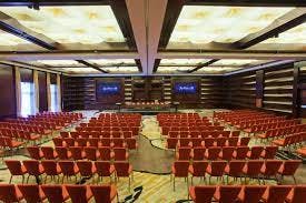 Spacious conference room with red chairs for presentations in Radisson Blu Hotel Bucharest.
