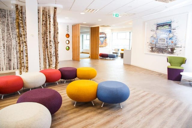 Modern meeting space in Leeds with colorful seating for creative events and brainstorming.