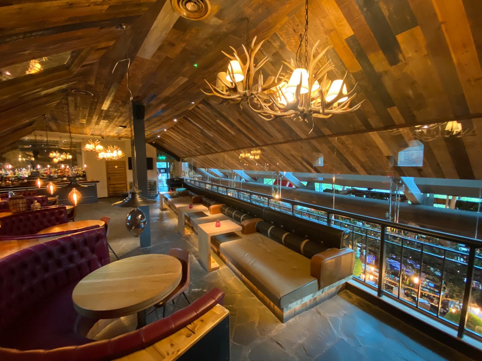 Stylish event space with wooden beams, perfect for networking and intimate gatherings. - Banner