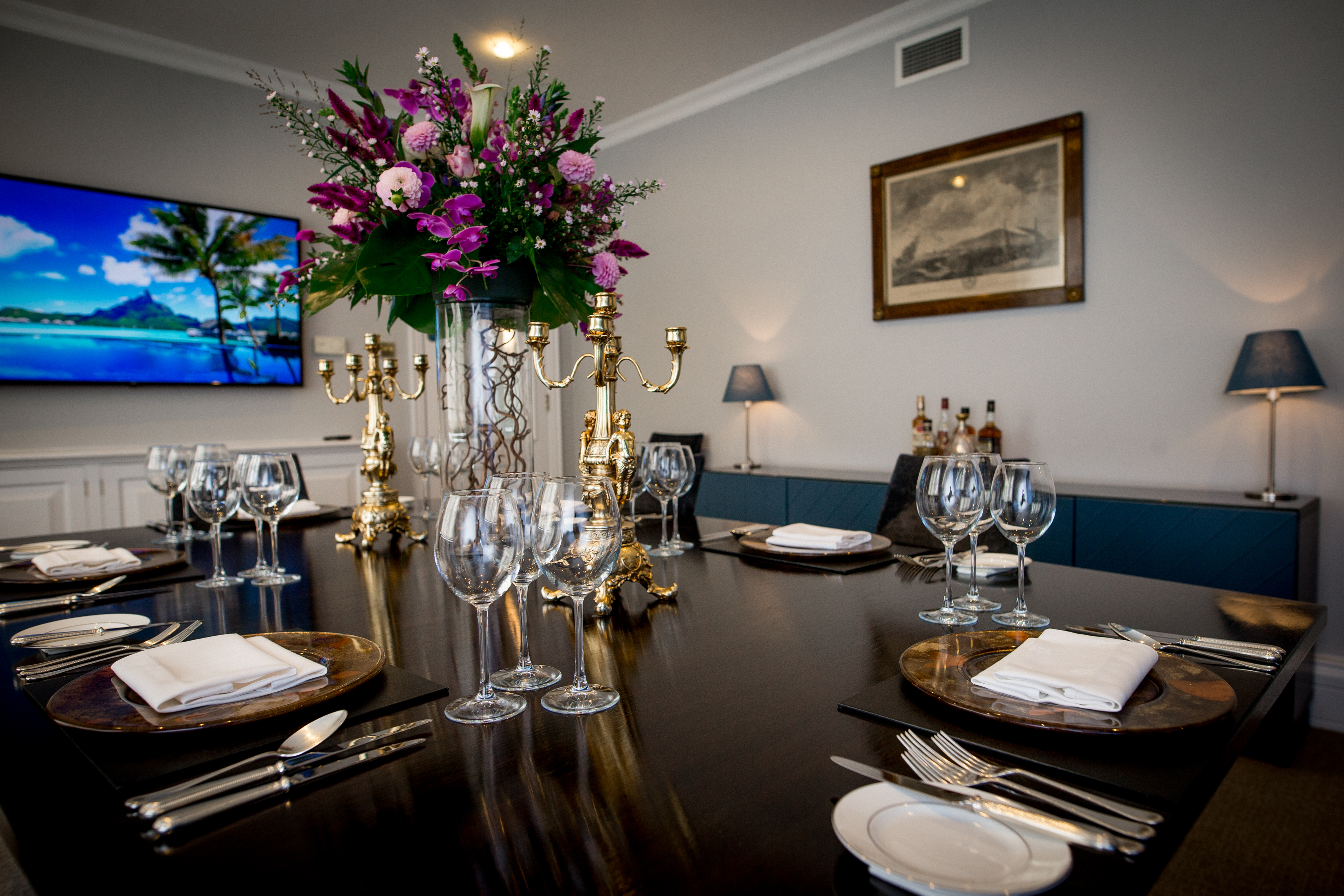 Thames Room at Arundel House, elegant meeting space with floral centerpiece for events. - Banner