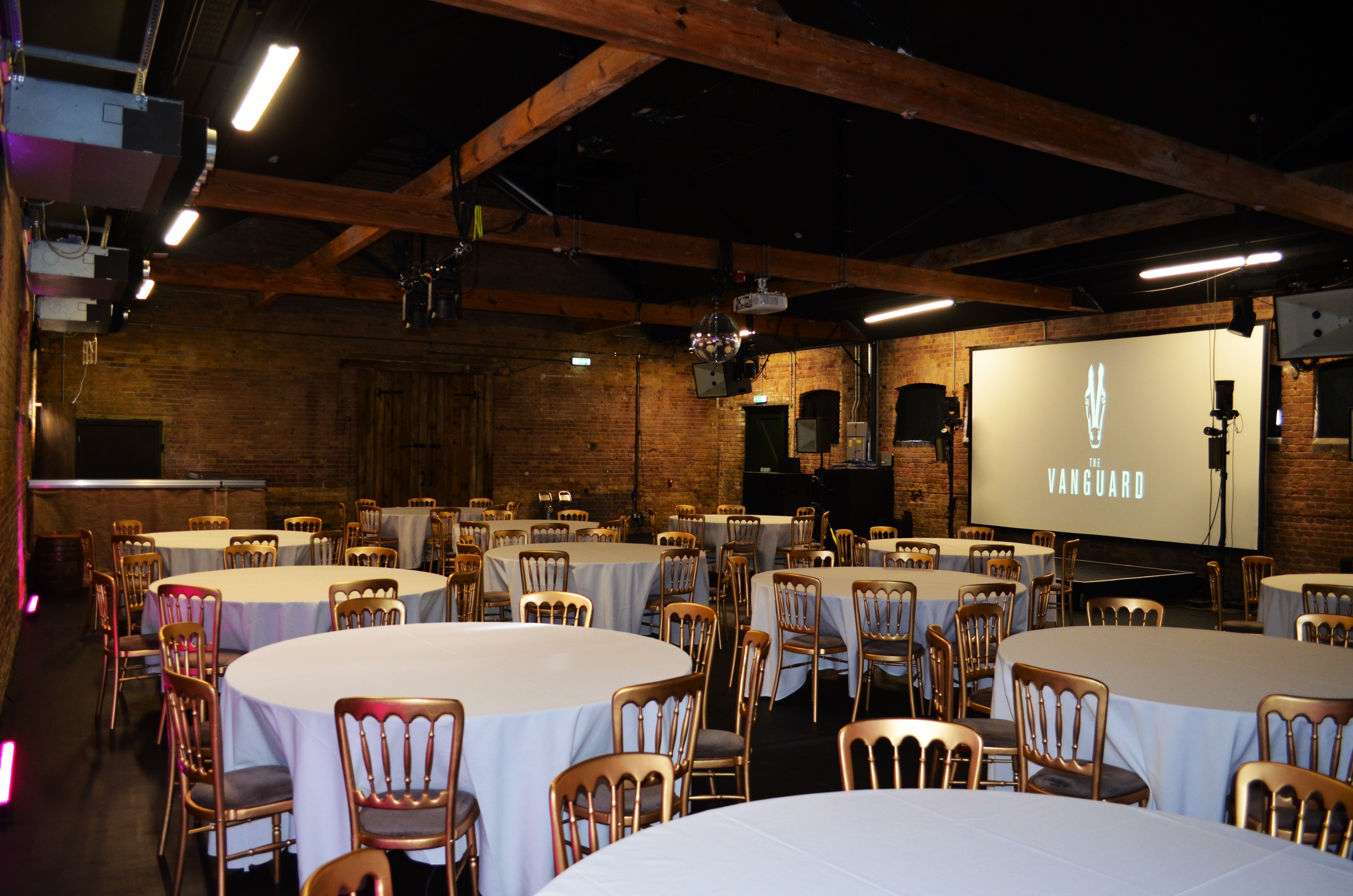 Versatile event space in Camden with round tables, ideal for corporate functions and gatherings.