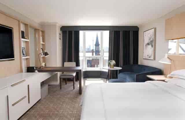 Spacious hotel room at Yorkville Royal Sonesta, ideal for business travelers and meetings.