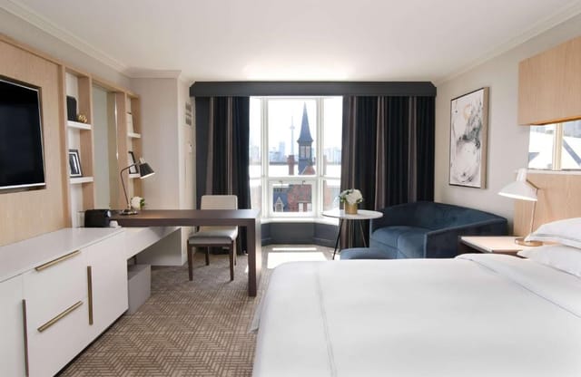 Spacious hotel room at Yorkville Royal Sonesta, ideal for business travelers and meetings.