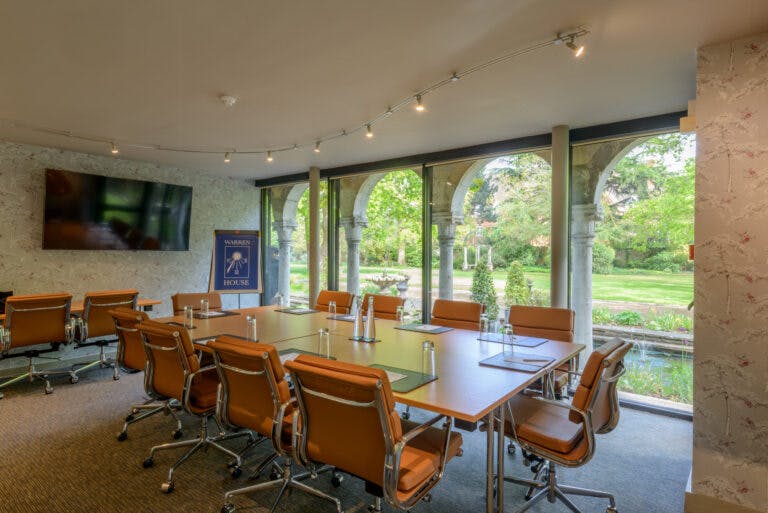 The Rose Room at Warren House Hotel, featuring a large table for productive meetings.