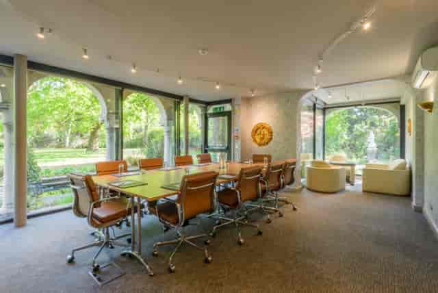 Rose Room at Warren House Hotel, bright meeting space with large conference table.