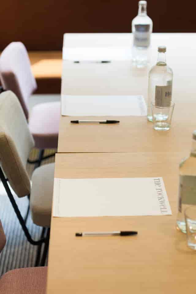 "Rockwell Hotel meeting room setup with minimalist tables for professional events."
