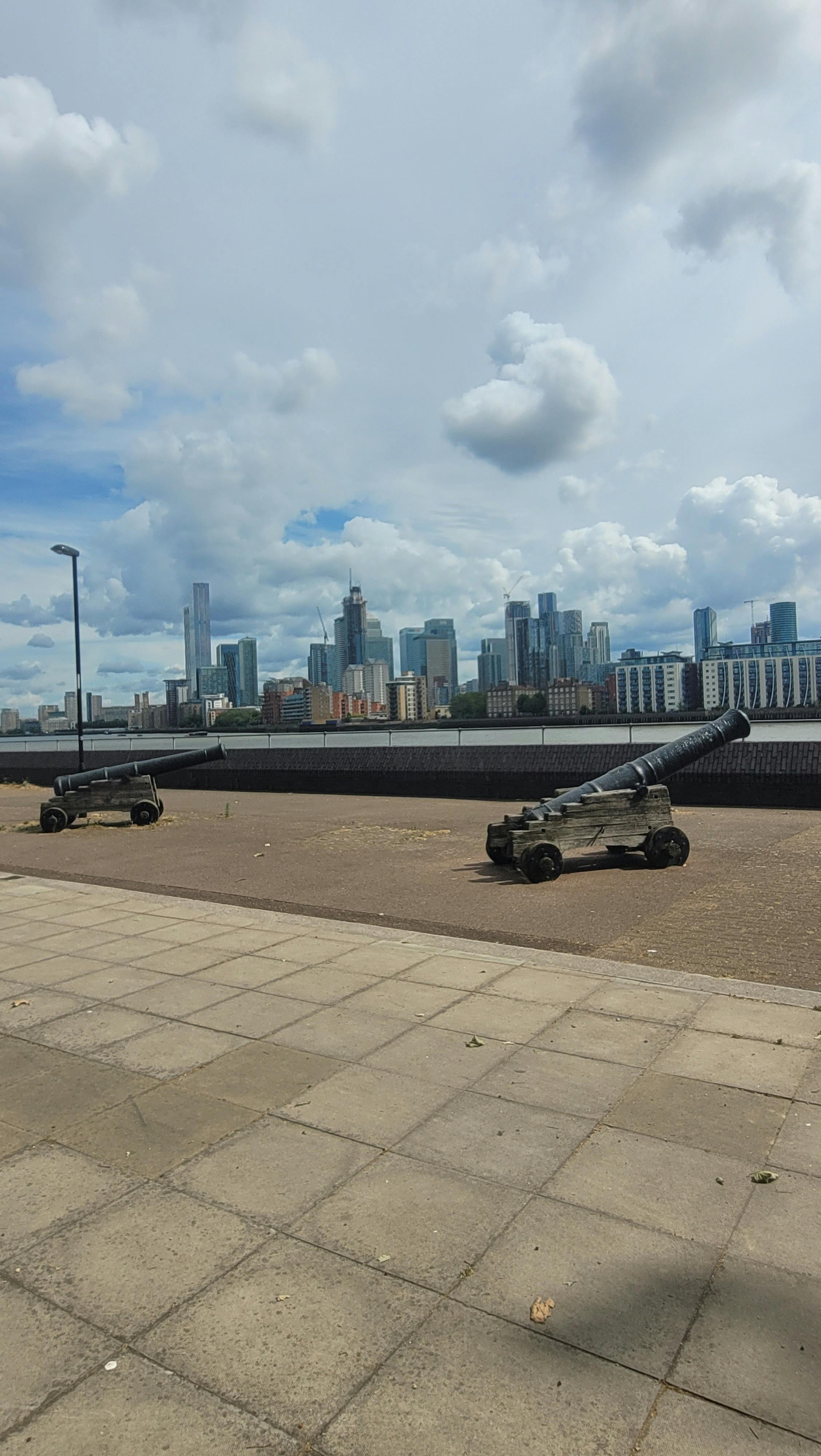 Basement venue with historical cannons and modern skyline, perfect for events.