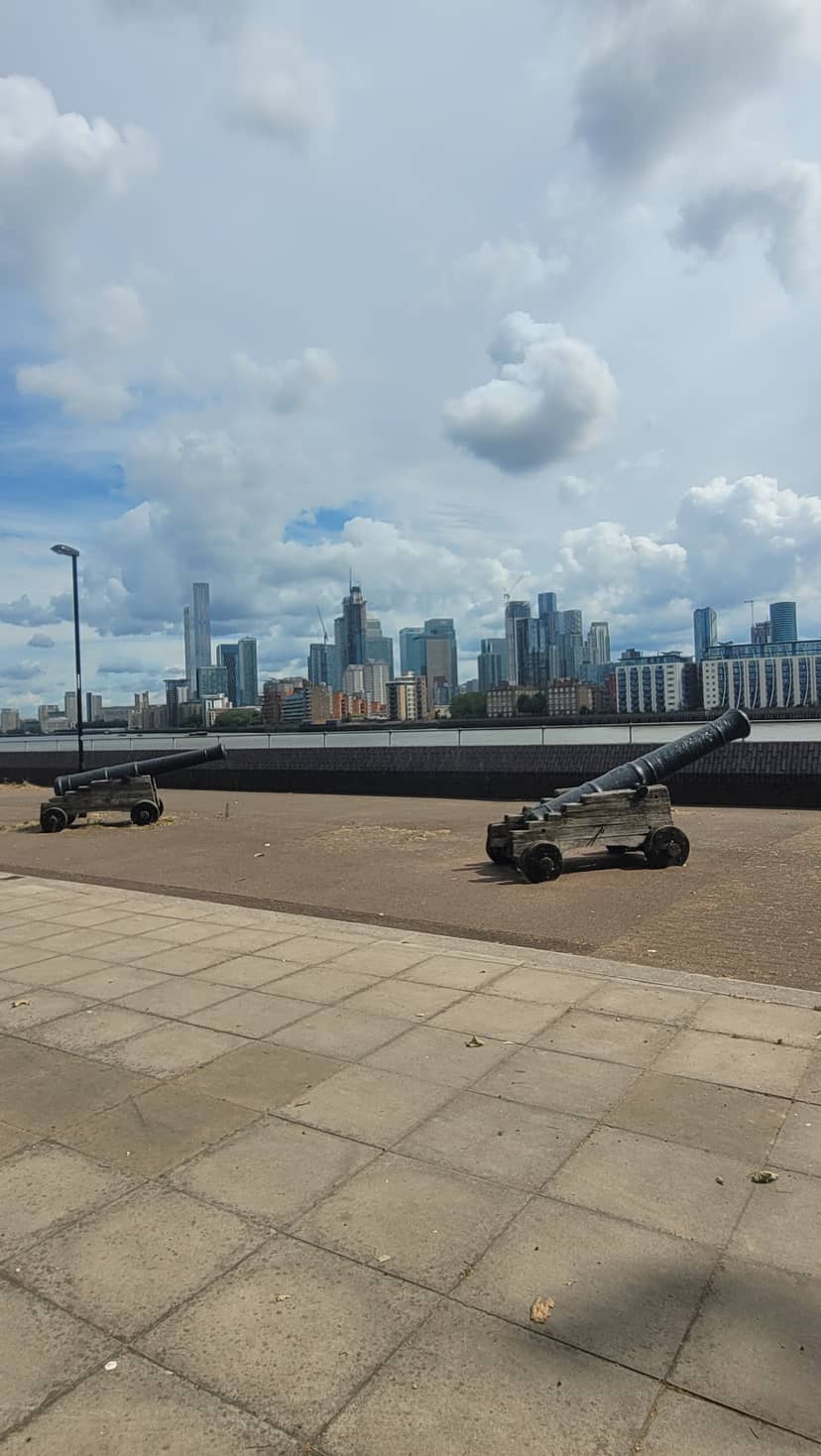 Basement venue with historical cannons and modern skyline, perfect for events.