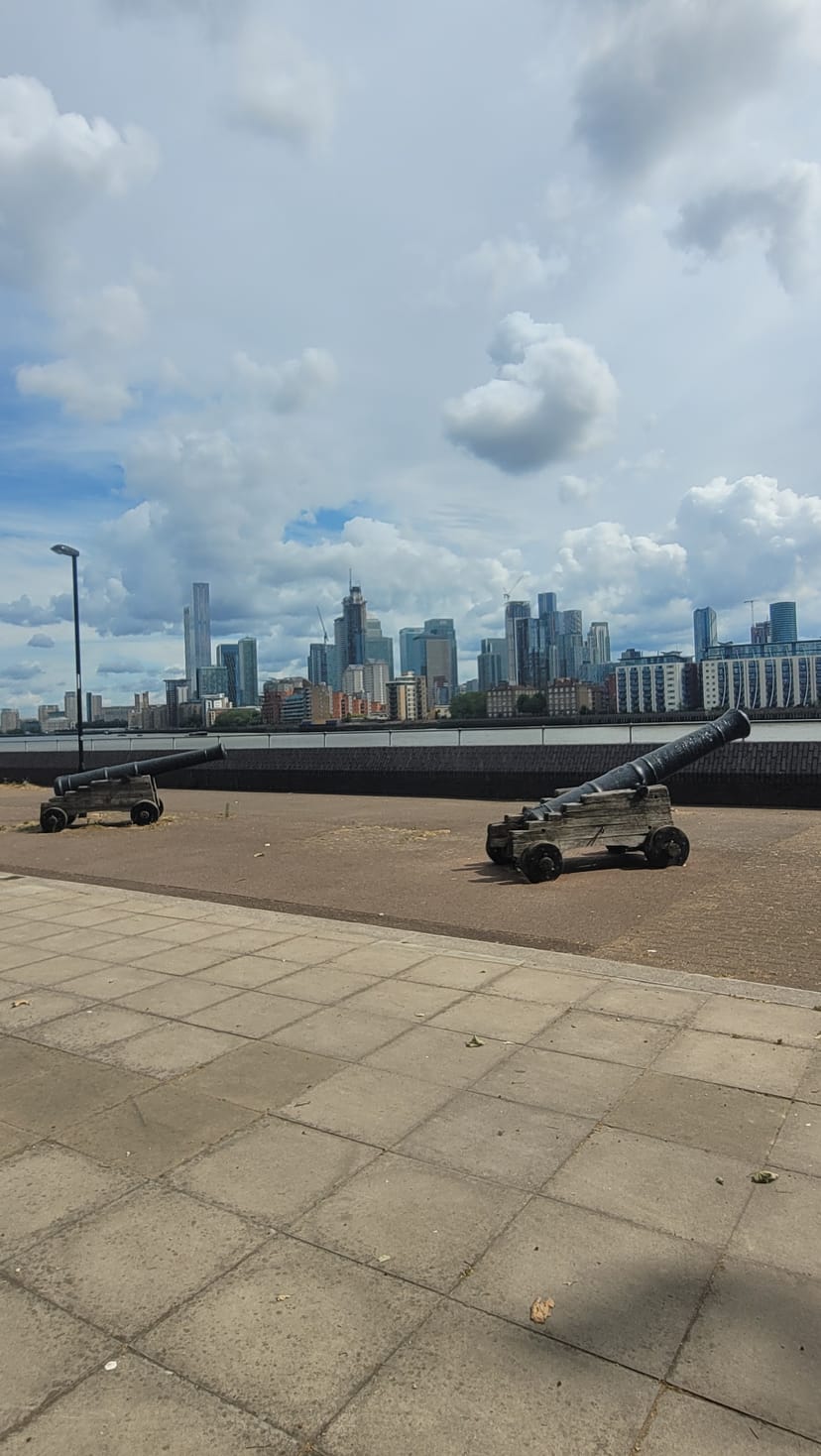 Basement venue with historical cannons and modern skyline, perfect for events.