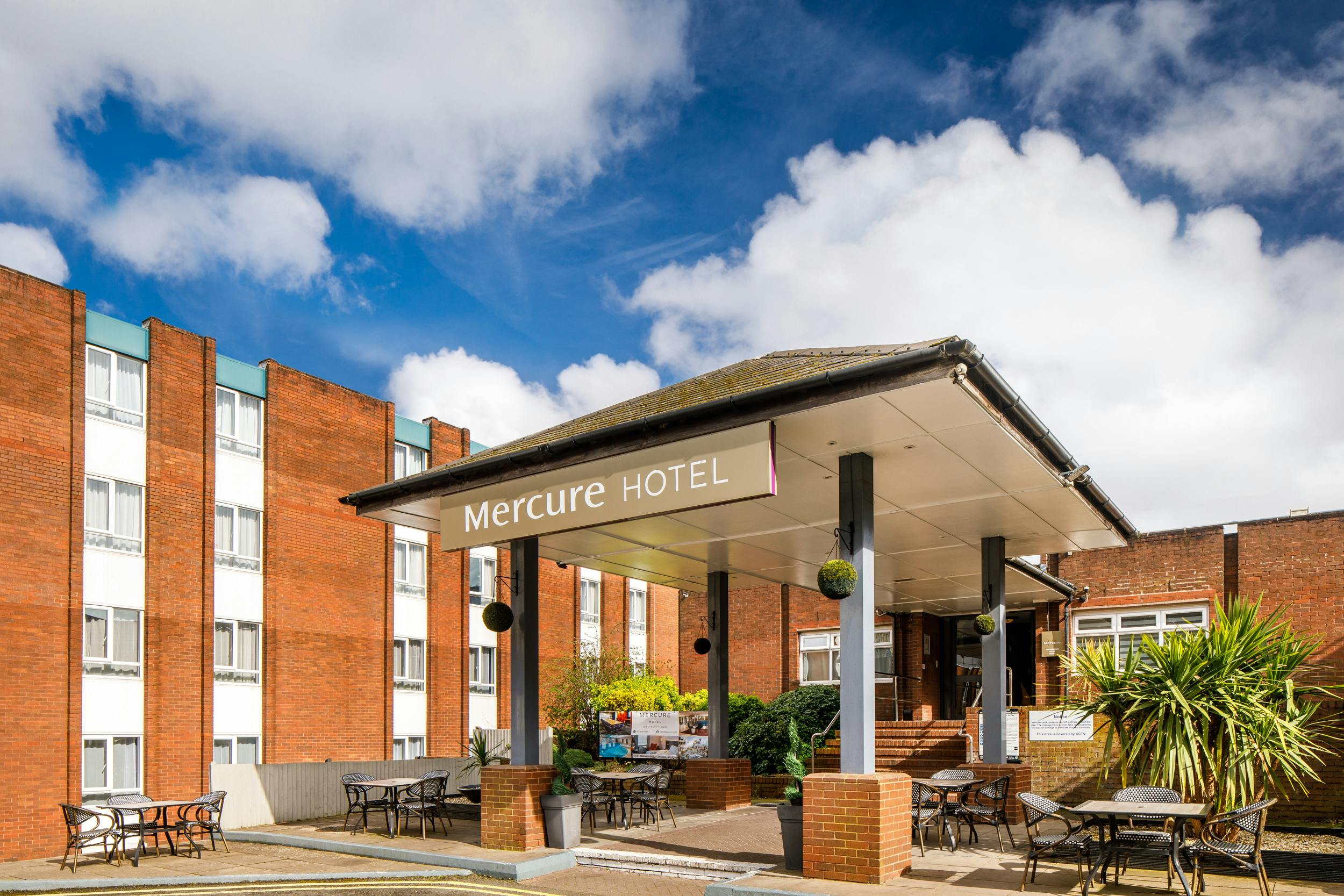 Mercure Birmingham West Hotel entrance with outdoor seating for events and meetings.