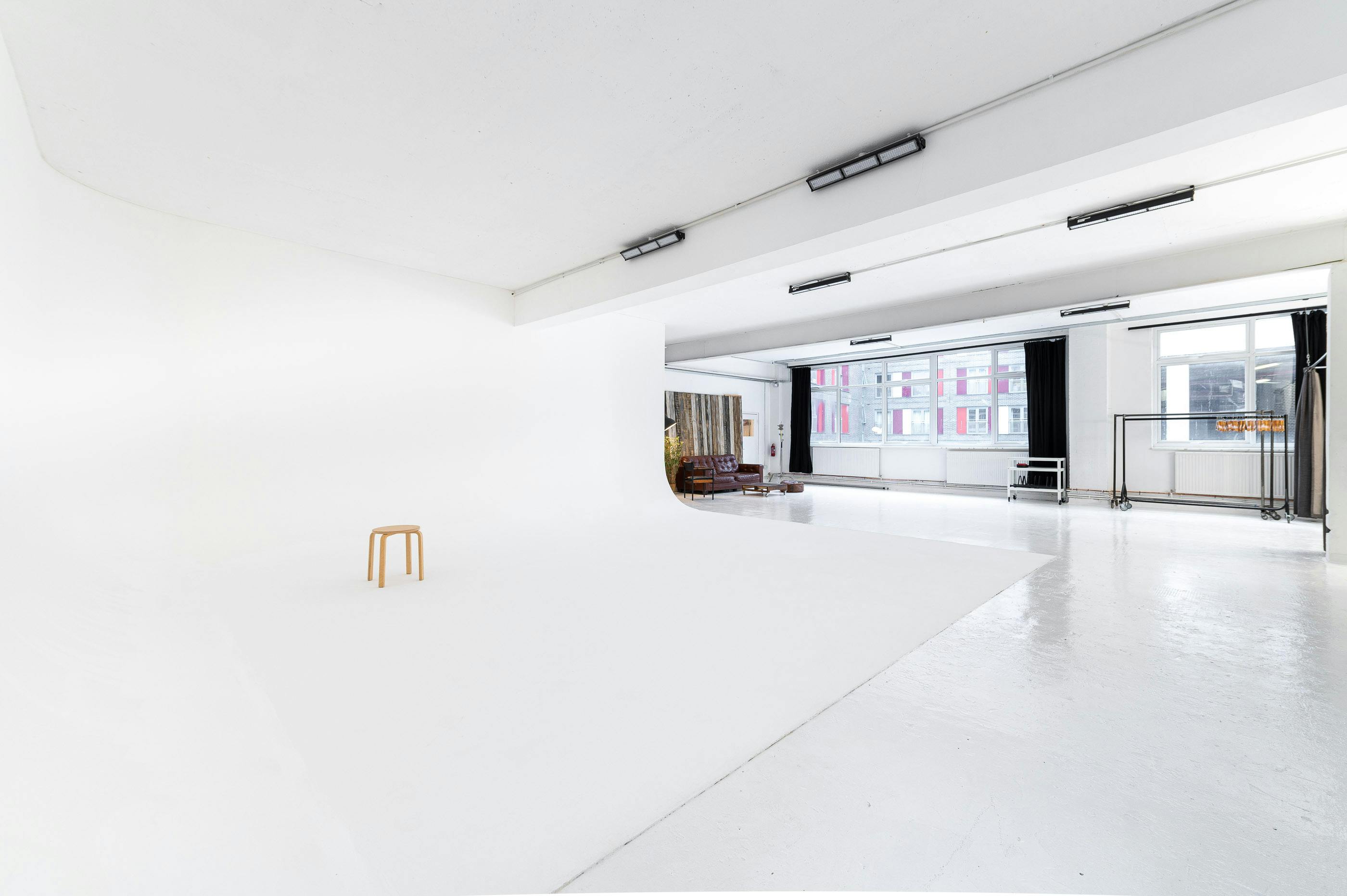 Versatile minimalist event space with natural light for workshops and photo shoots.