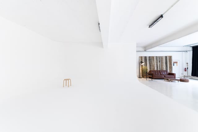 Versatile minimalist event space with natural light for workshops and gatherings.