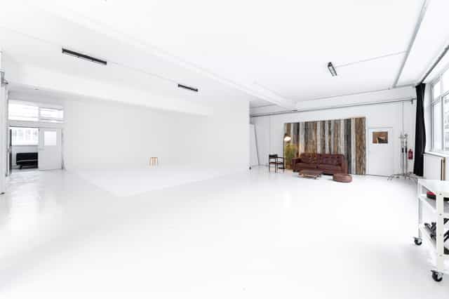 Versatile event space with bright white walls, perfect for workshops and photo shoots.