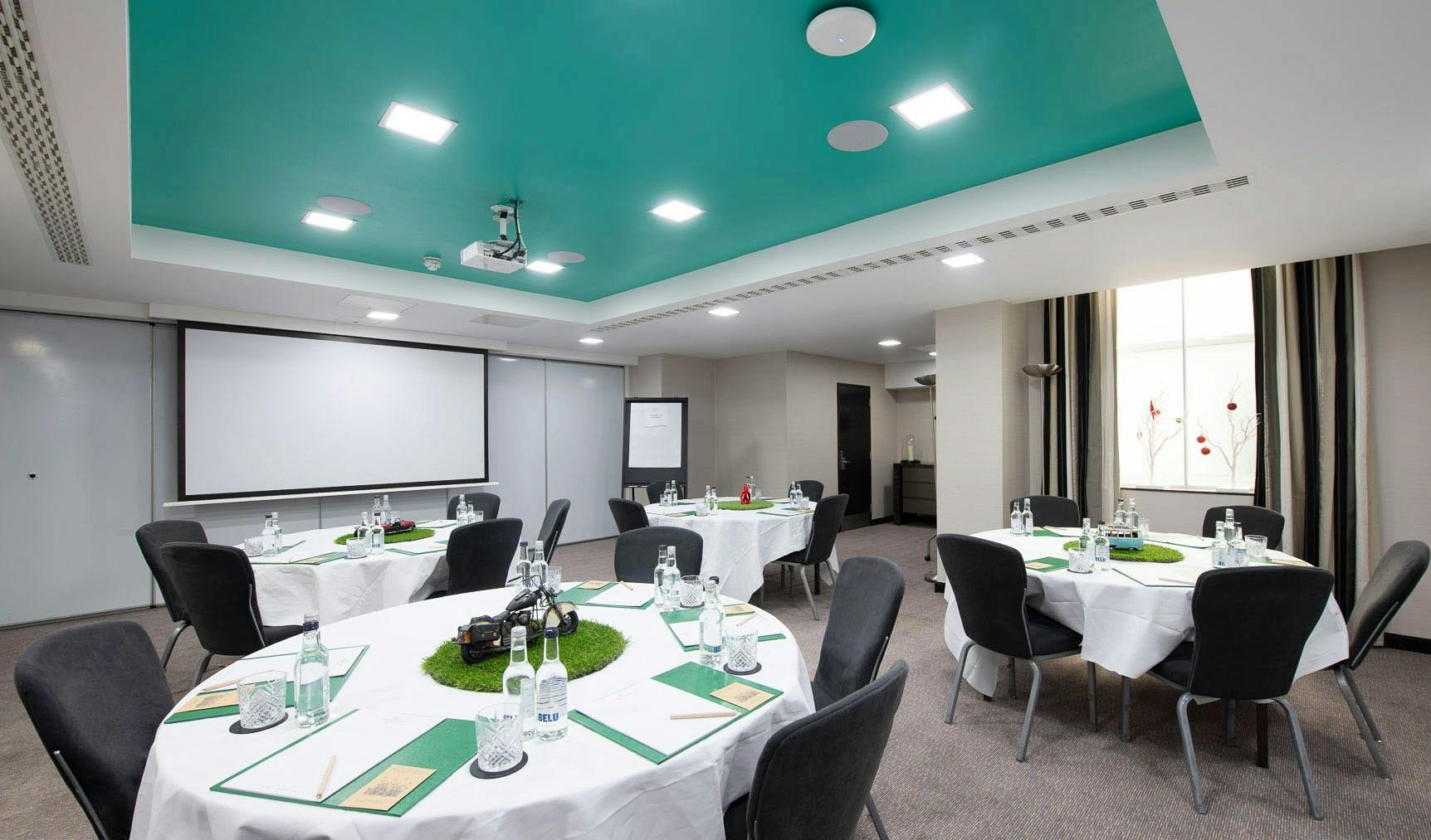 Cromwell 2 meeting room at DoubleTree London, featuring round tables for corporate events.