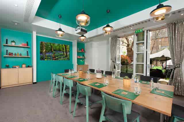 Modern meeting room with wooden table, ideal for workshops at DoubleTree London Kensington.