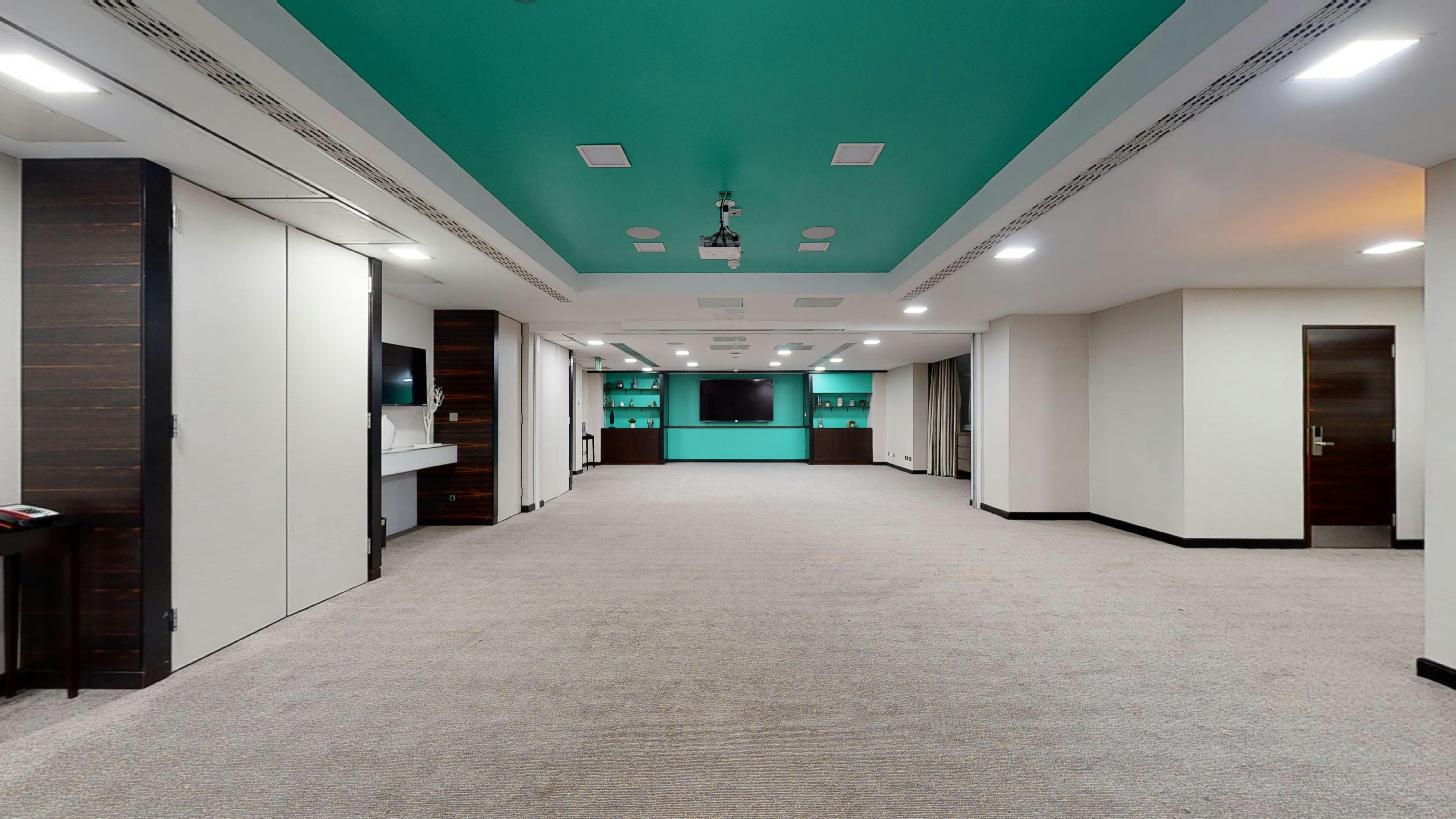 Modern meeting space with teal ceiling for presentations and workshops at DoubleTree Kensington.