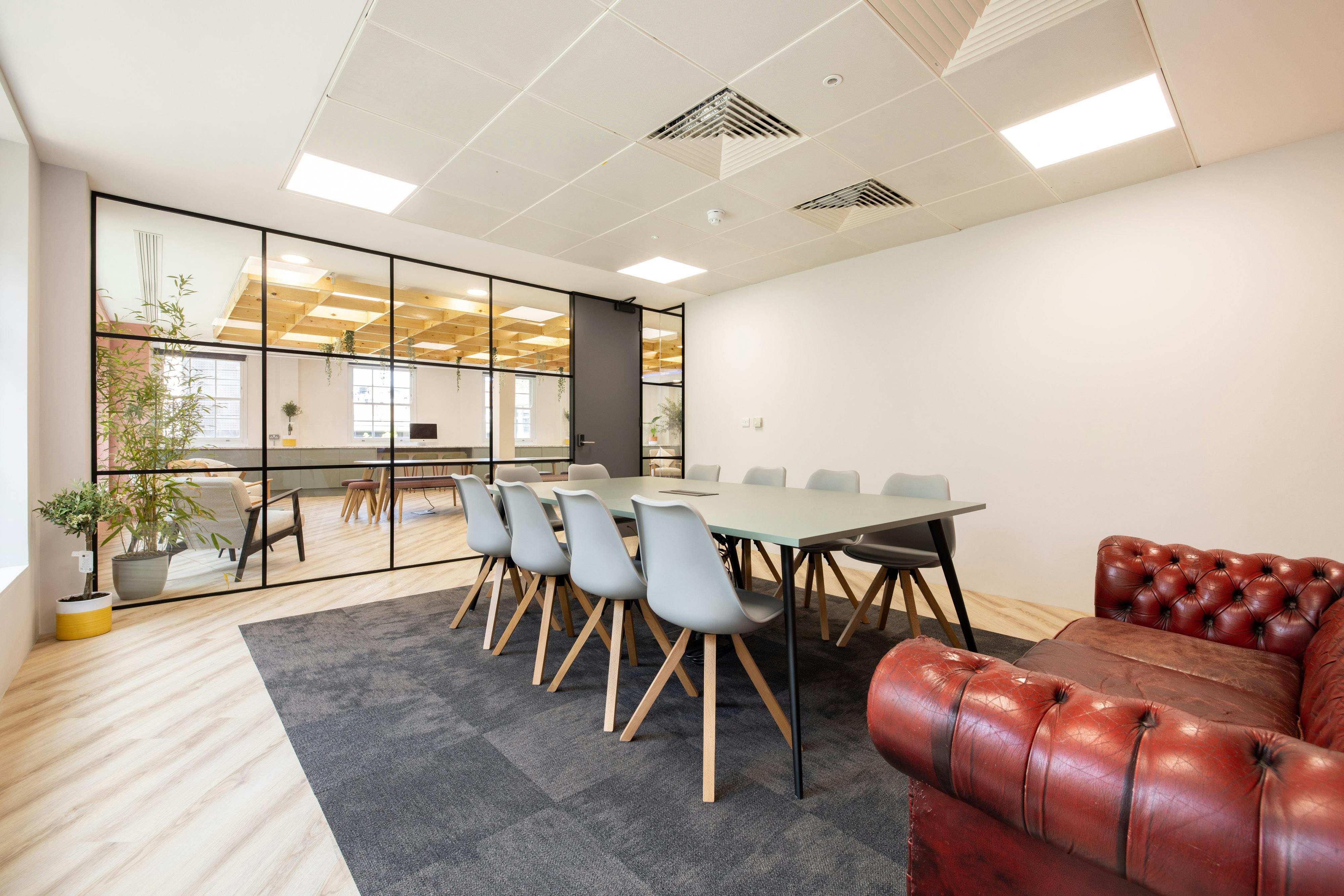 Charles Fowler in a modern meeting room with glass walls, ideal for collaborative events.