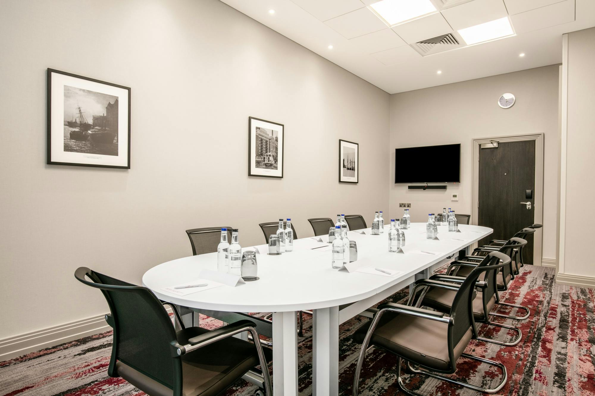 Manhattan Suite at Crowne Plaza: modern meeting room with oval table, ideal for conferences.