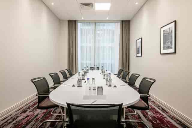 Butler Suite meeting room at Crowne Plaza London Docklands, featuring a sleek oval table.
