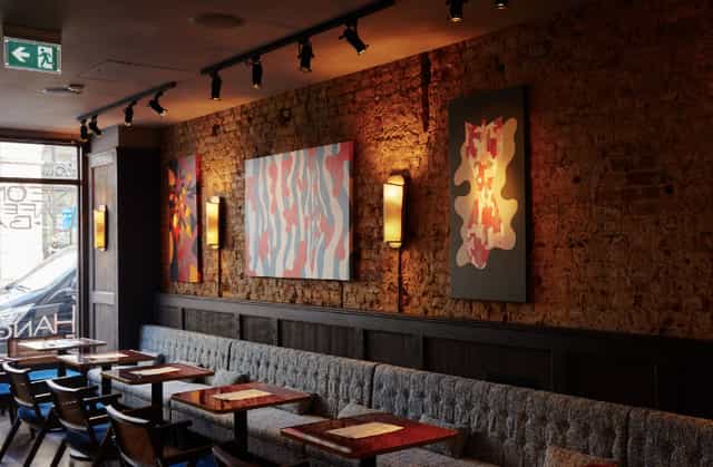 Stylish NEON194 bar with exposed brick, perfect for networking events and meetings.
