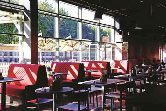 Gasworks Kitchen at Southampton FC: modern dining with red booths, perfect for networking events.