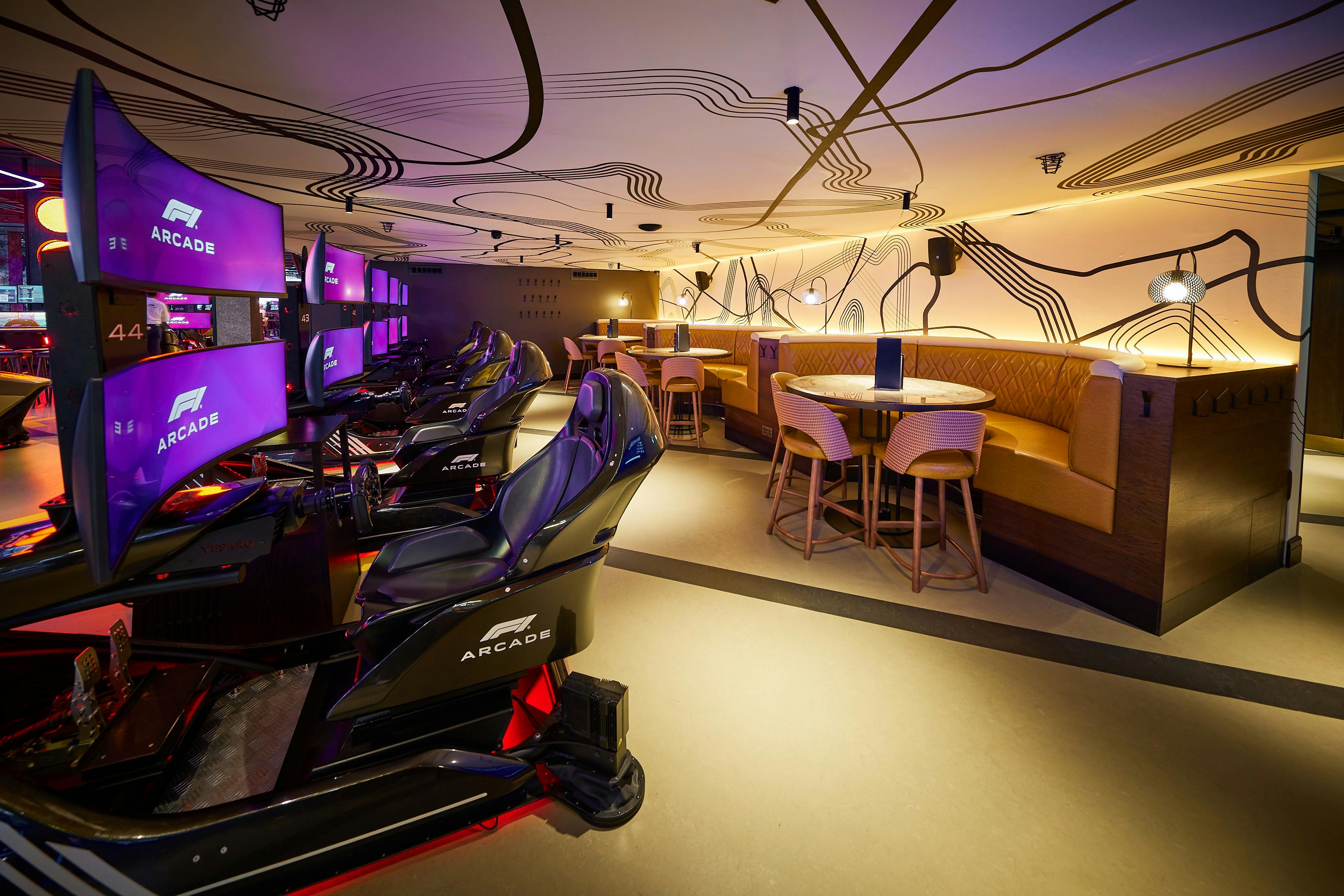 Modern event space with arcade stations and cozy seating for team-building activities.