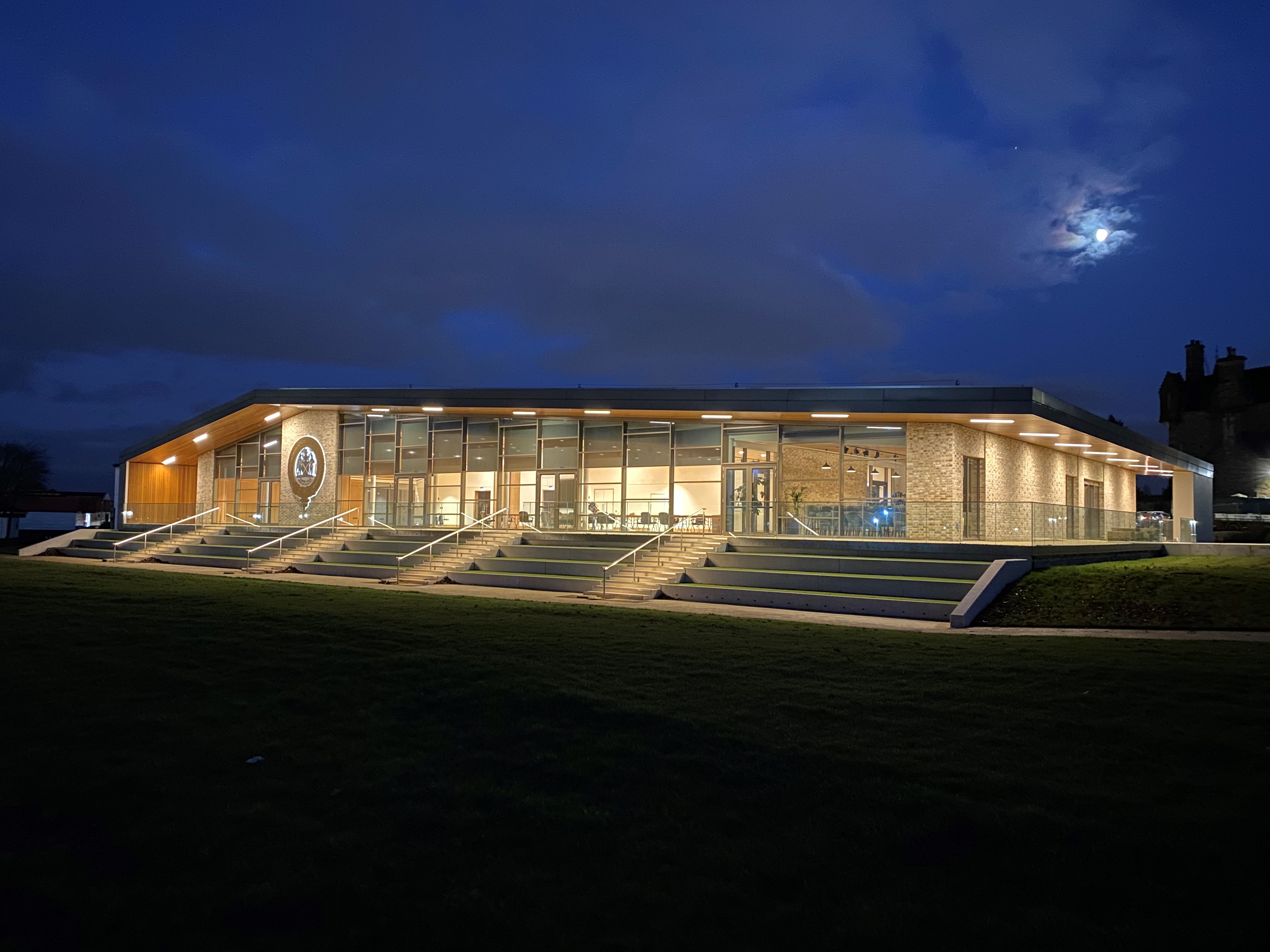 Modern event venue at dusk with glass windows, ideal for corporate and social gatherings.