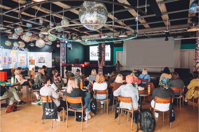 Main room at Strange Brew with hanging globes, ideal for meetings and events.