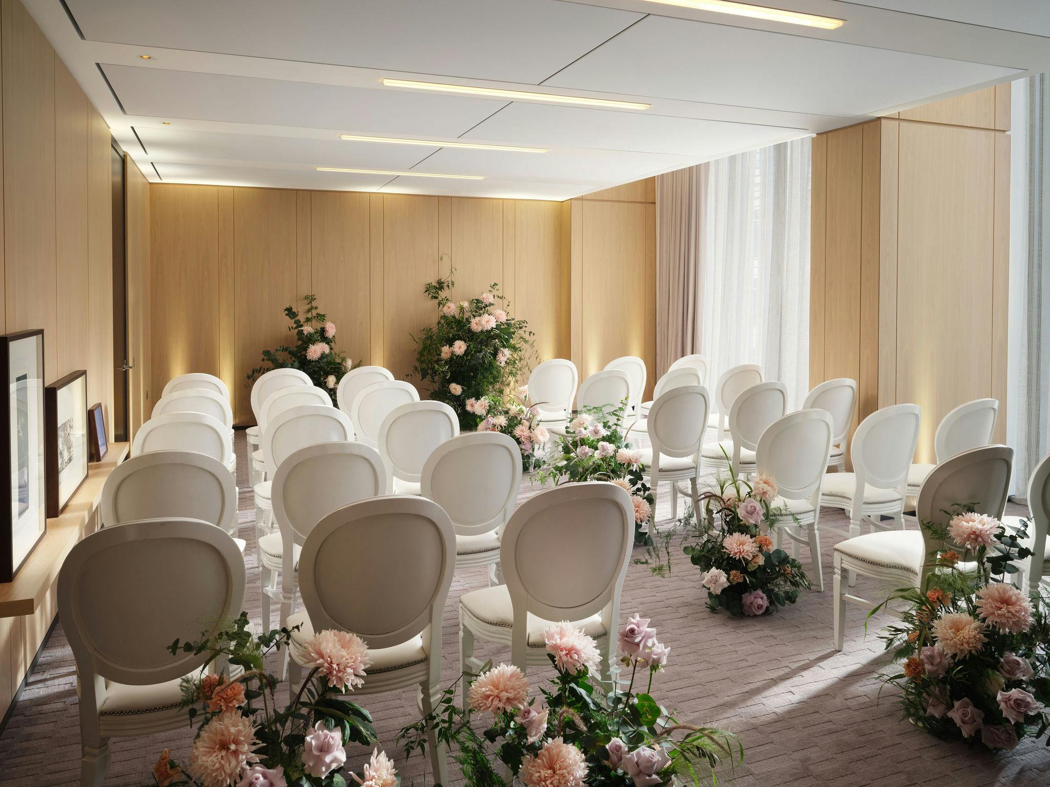 Four swans in elegant event space with floral decor, ideal for intimate gatherings.