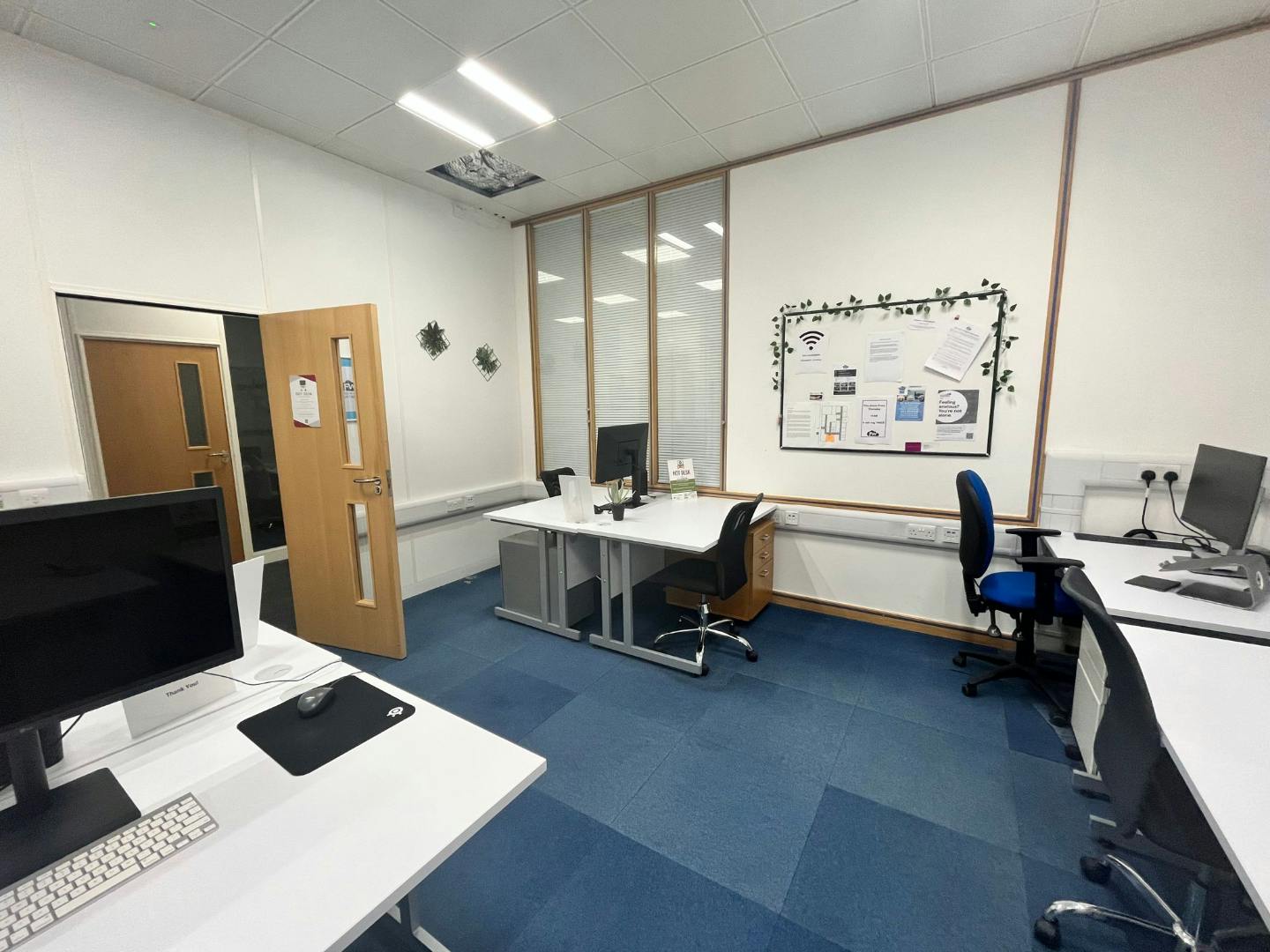 Modern hot desk office with glass partitions for collaboration in Gatwick.