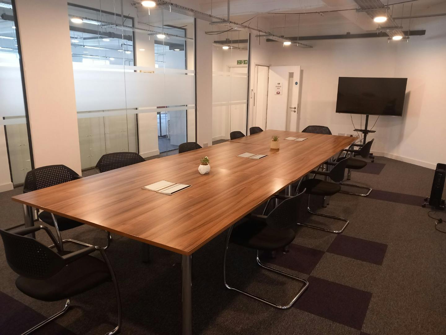 Modern conference room with wooden table, ideal for meetings and events in Hastings.