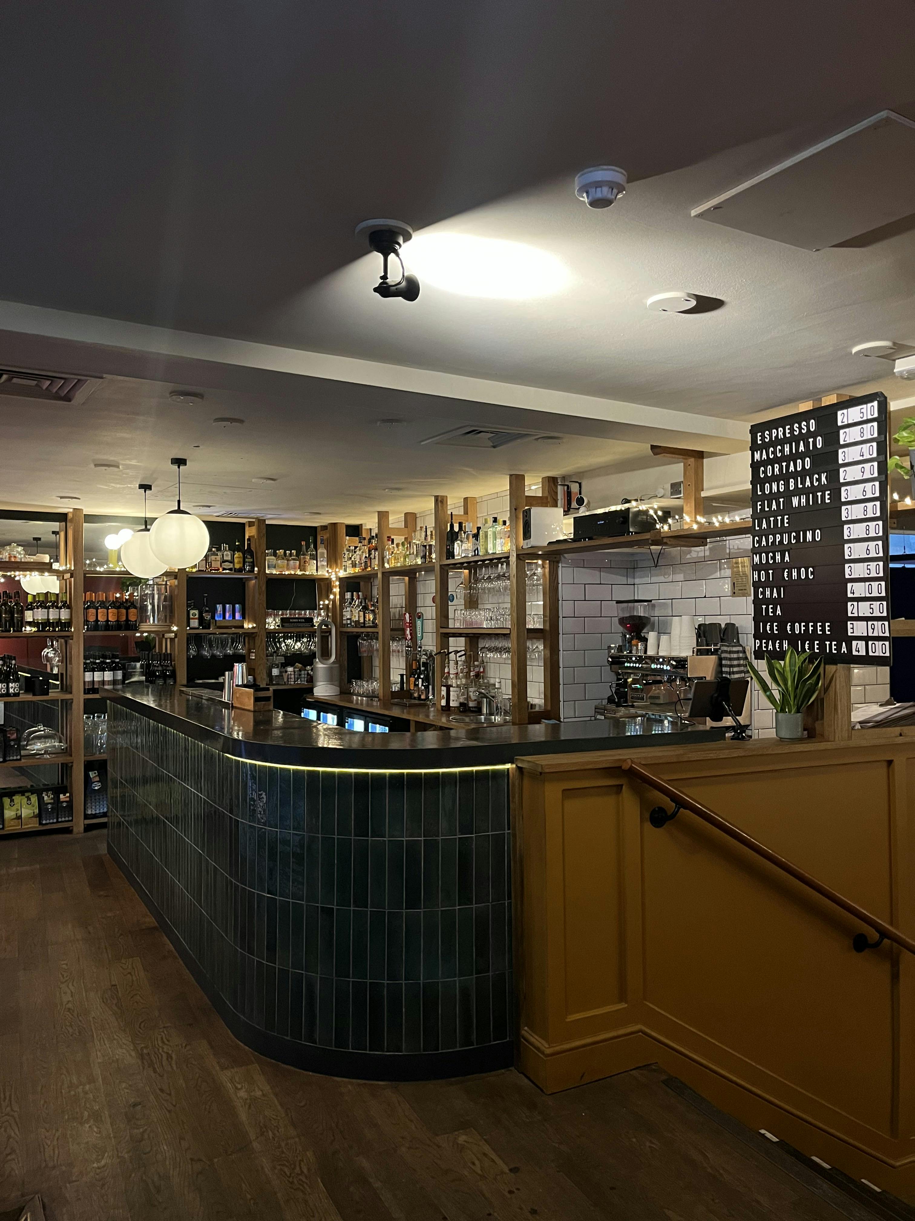 Stylish café bar with sleek counter, ideal for networking and team-building events.