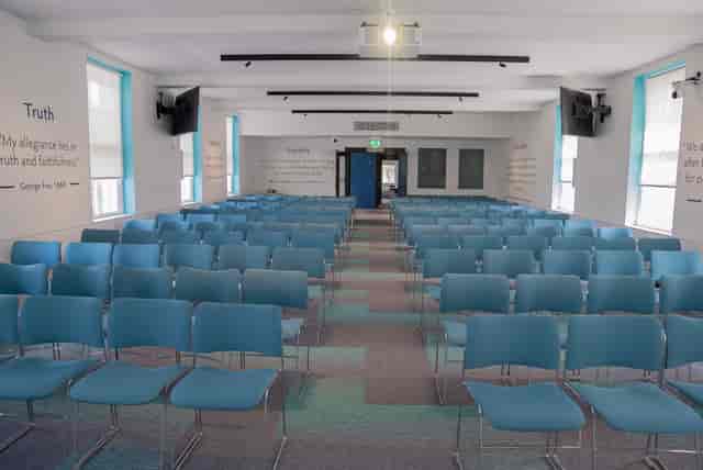 Event space with modern blue chairs, ideal for workshops and presentations.