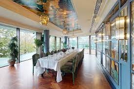 Elegant dining space with long table in Butterfly Room, ideal for events and meetings.