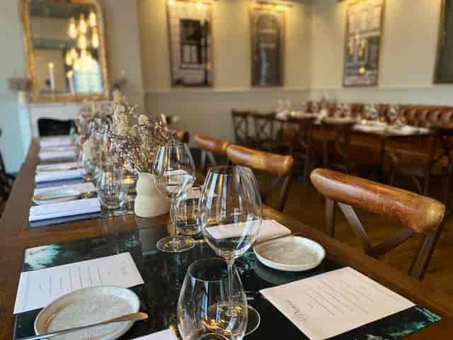 Elegant private dining room with polished glassware, ideal for corporate dinners and gatherings.