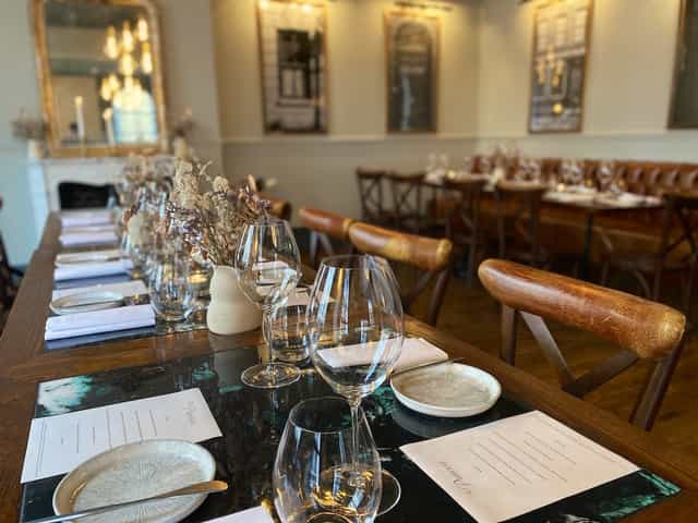 Elegant private dining room with polished glassware, ideal for corporate dinners and gatherings.