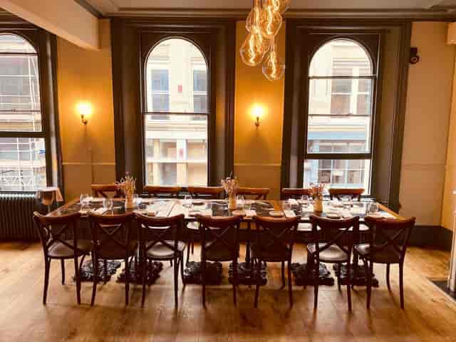 Private dining room with elegant tableware, ideal for intimate corporate events.