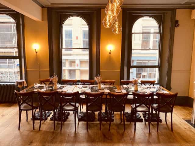 Private dining room with elegant tableware, ideal for intimate corporate events.
