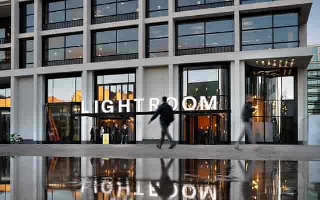 Modern event venue Light Room with large glass windows, perfect for upscale gatherings.
