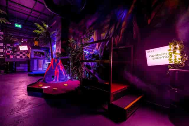 Pablo at Junkyard Golf Club, vibrant event space with dramatic lighting for team-building.