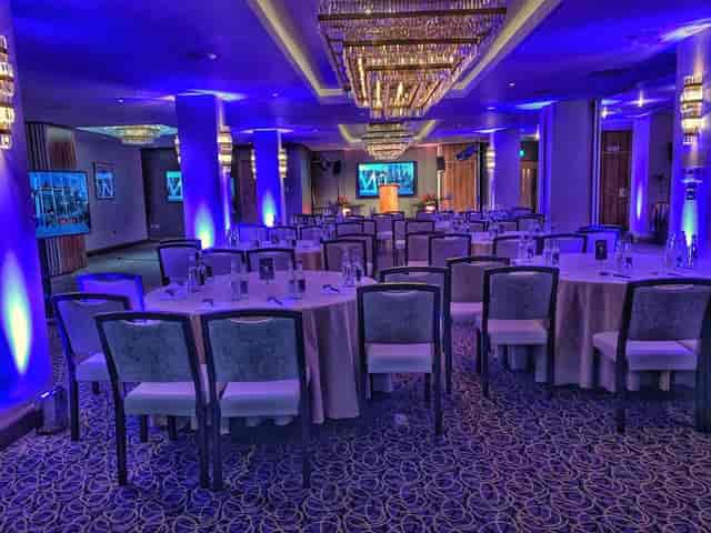 Elegant event space in Royal London House with round tables, perfect for corporate meetings.