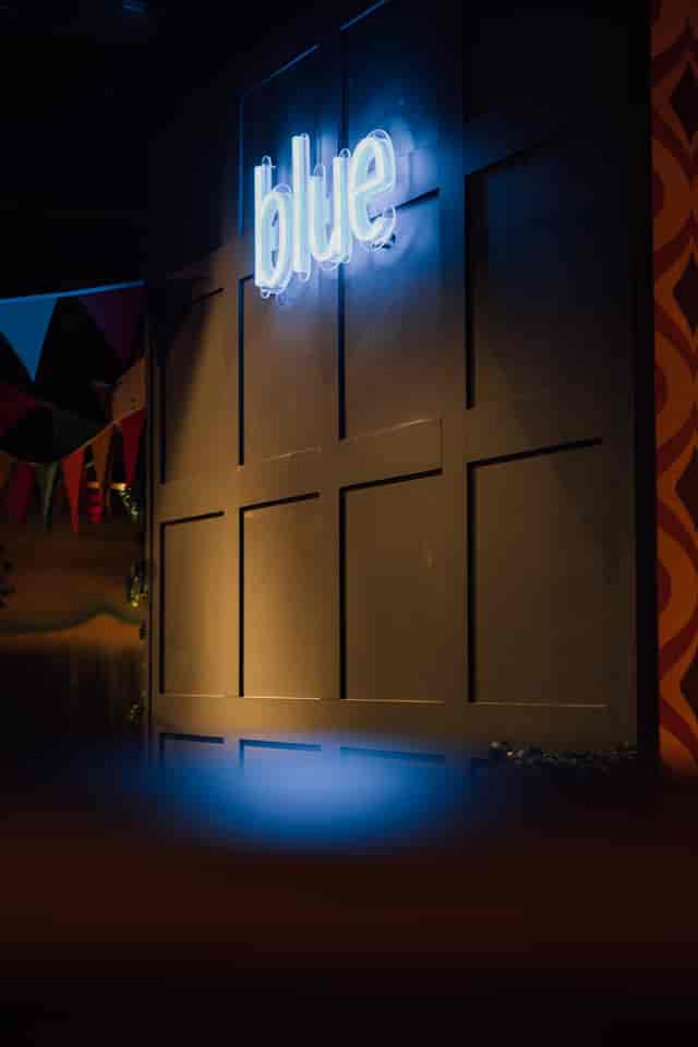Versatile event space in Caddies Crawley with textured wall and festive bunting for celebrations.