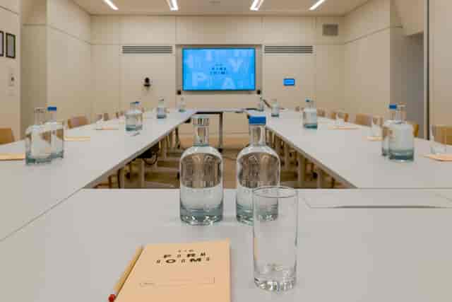Professional meeting room with long tables, ideal for conferences and collaboration.